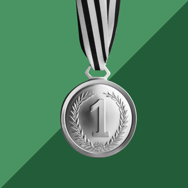 A black and white first-place medal set against a light green and dark green background